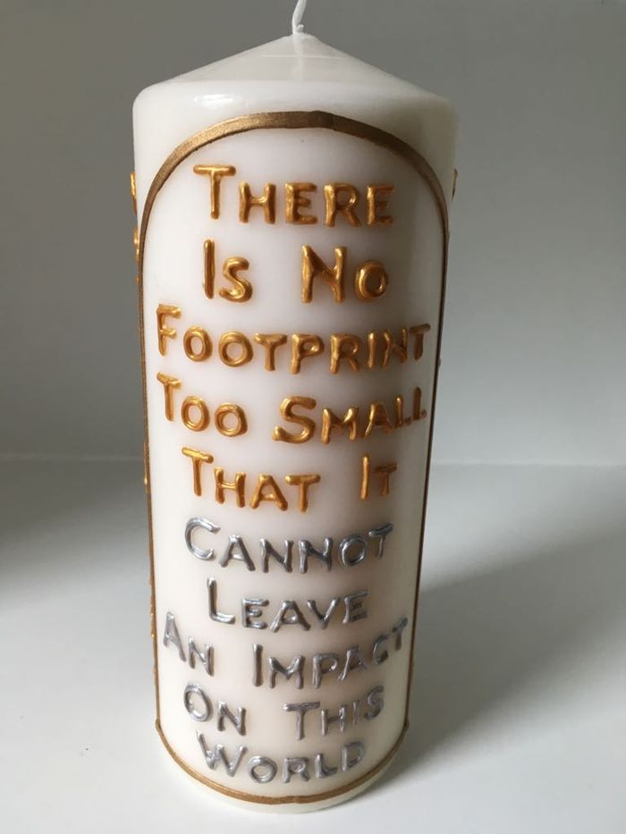 Candle lettered: There is no footprint too small that it cannot leave an impact on this world