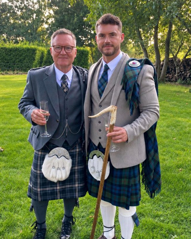The two founders of the Special Candle Trust in kilts, standing together on a lawn